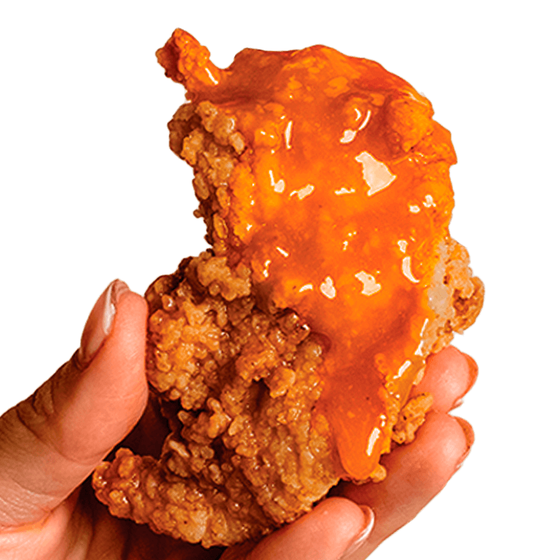 Honey Garlic Chicken Finger Miami A hand holds a delicious honey garlic chicken finger from Kung Fu Chicken, the best Asian fried chicken in Miami.